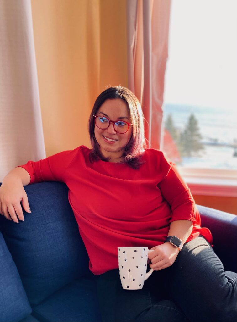 Women in red shirt sitting on blue couch