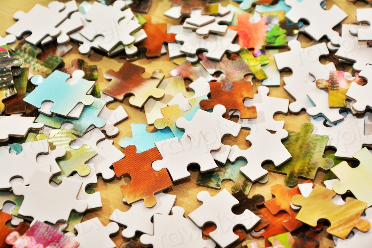 Puzzle pieces of different colours and shapes on a table